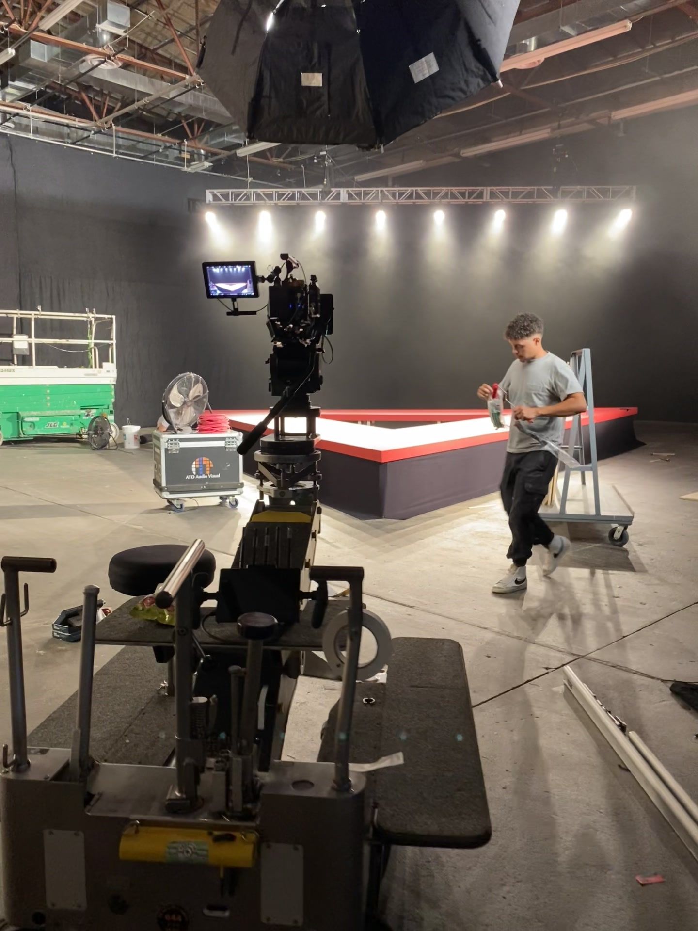 dolly with operator, stage behind (video frame)